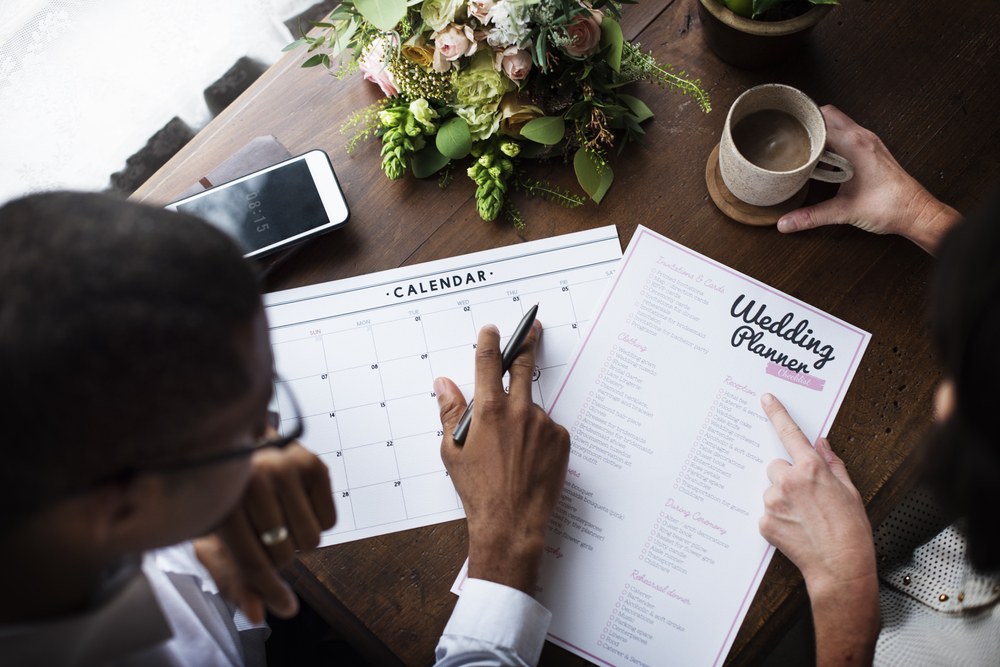 Couple planning wedding dates and guest list